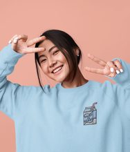 Load image into Gallery viewer, Model wearing a blue diary is scary milk carton embroidered vegan sweatshirt
