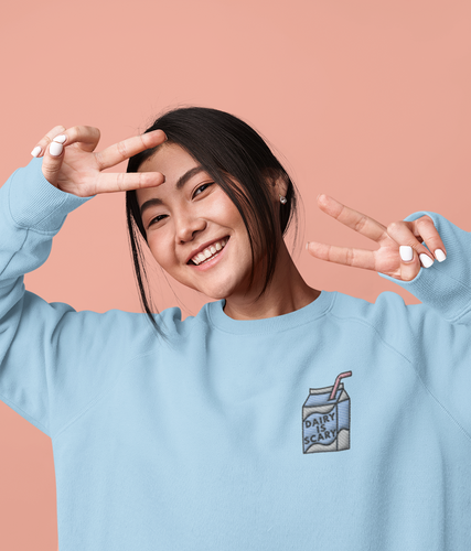 Model wearing a blue diary is scary milk carton embroidered vegan sweatshirt