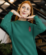 Load image into Gallery viewer, Red haired model wearing a green hot sauce sriracha sweatshirt