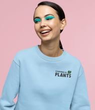 Load image into Gallery viewer, Blue powered by plants embroidered sweatshirt on a female model
