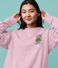 Load image into Gallery viewer, Asian model wearing pink embroidered spread hummus not hate vegan sweatshirt.
