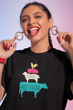 Load image into Gallery viewer, Woman wearing a black vegan shirt with farm animals and the words we are friends not food
