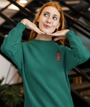 Load image into Gallery viewer, Red haired model wearing a green hot sauce sriracha sweatshirt
