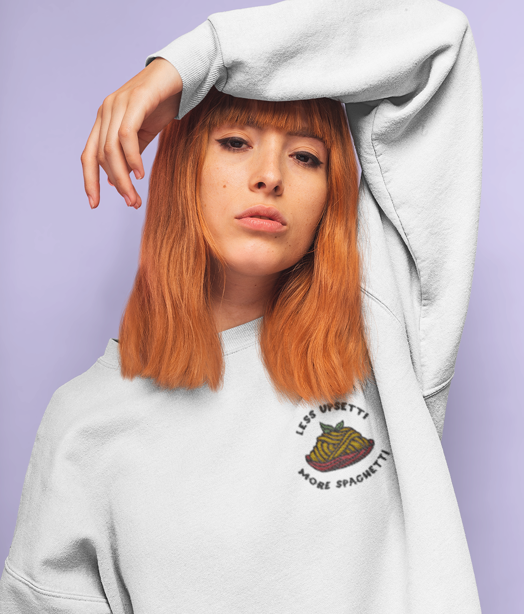 Model wearing a white less upsetti, more spaghetti embroidered sweatshirt