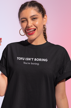 Load image into Gallery viewer, Woman wearing black vegan t-shirt with the words tofu isn&#39;t boring, you&#39;re boring
