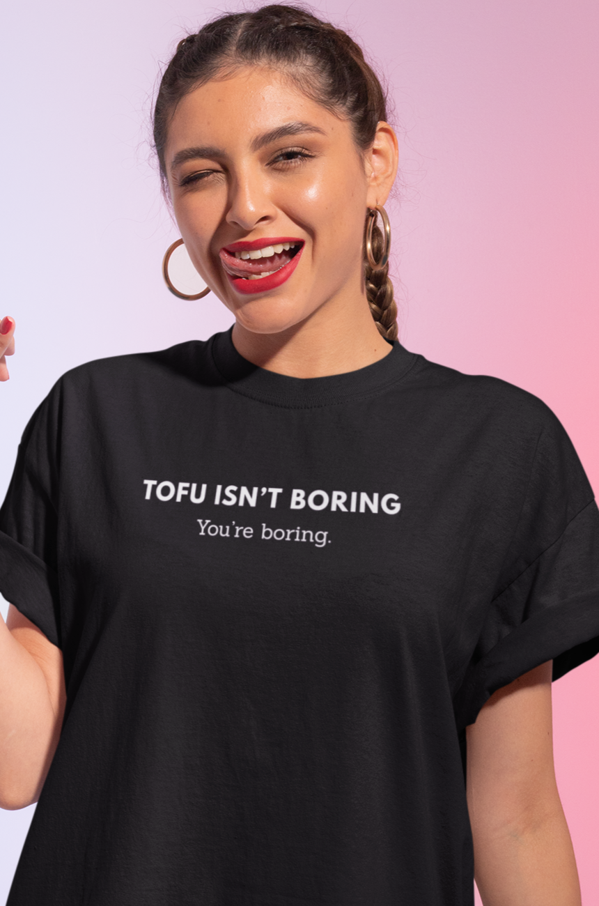 Woman wearing black vegan t-shirt with the words tofu isn't boring, you're boring