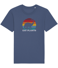 Load image into Gallery viewer, Blue vegan shirt with a picture of a dinosaur in a rainbow sun and the words eat plants.
